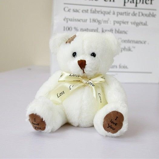 eef2874a-d893-4d81-8018-3876efcb9d8a_e15a4562-7594-4081-929e-5b5c8b09ee1b.jpg Ours en peluche avec un petit nœud